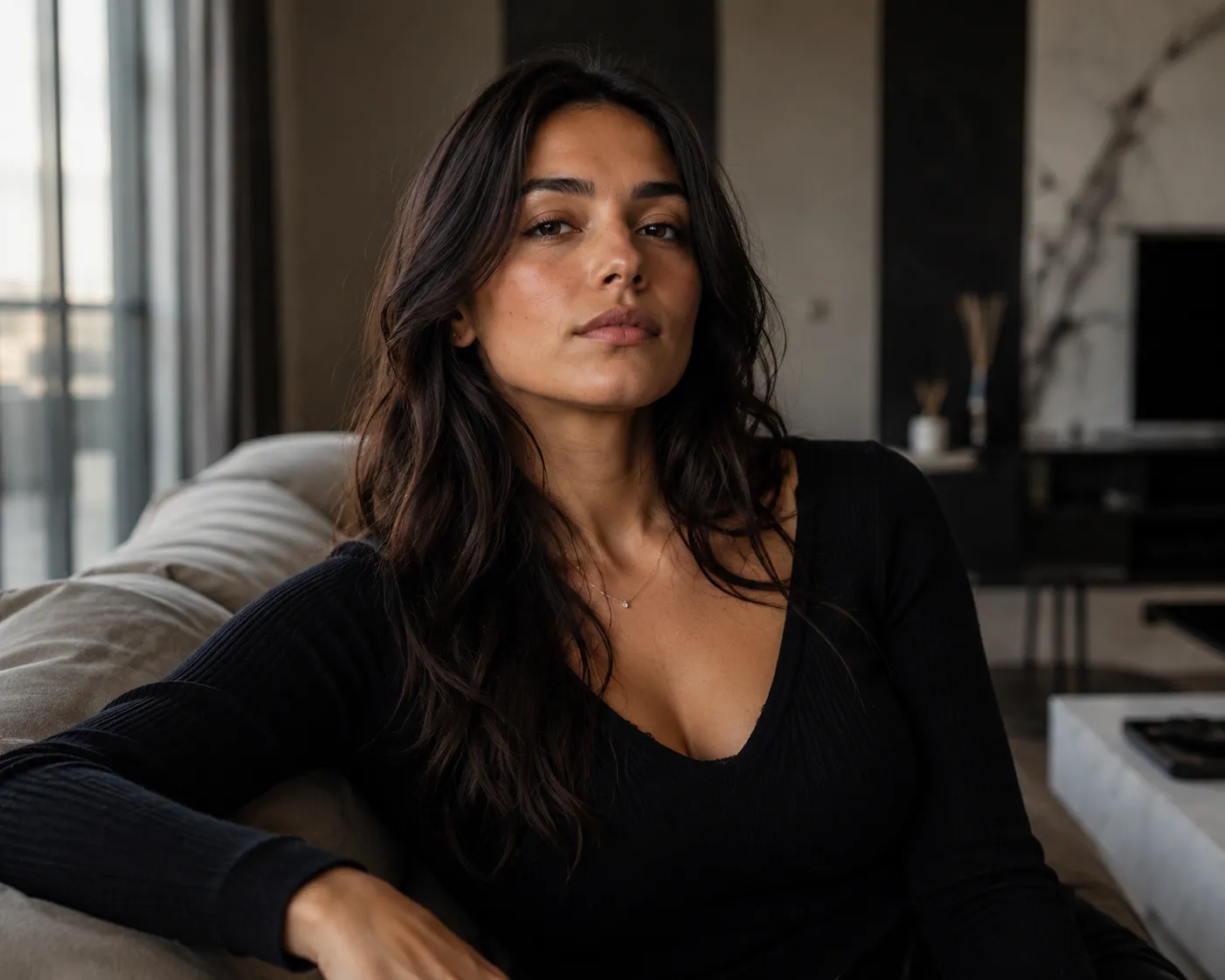 Elegant dominant woman with calm confident expression in a luxury apartment